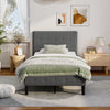 Gray platform bed with tufted headboard and padded side rails, offering modern style and sturdy support for your.