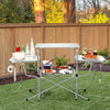 Foldable outdoor BBQ table with aluminum countertop, side shelves, and hooks, perfect for camping and backyard grilling.