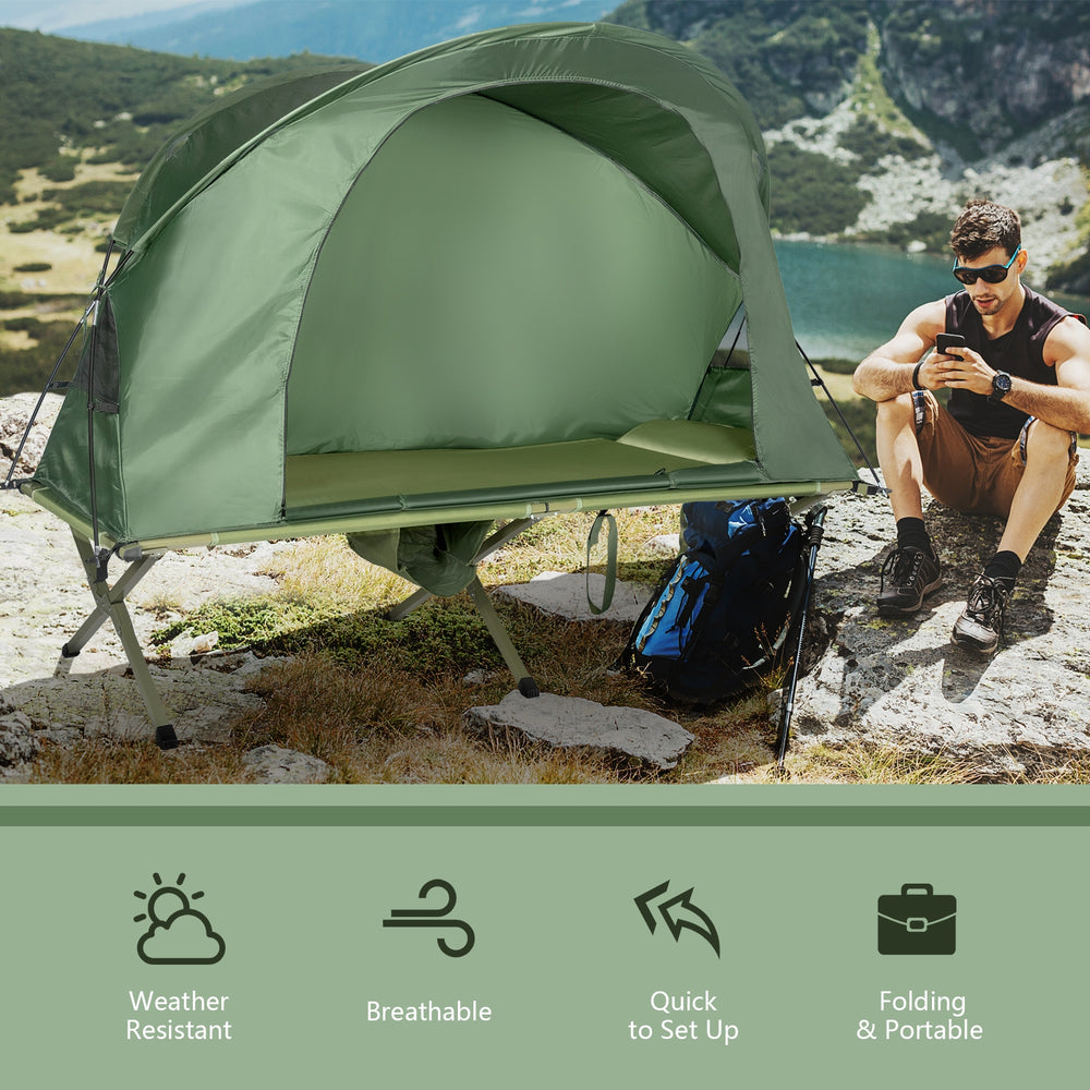 Elevated compact tent set in green with external cover, ideal for camping and outdoor relaxation.