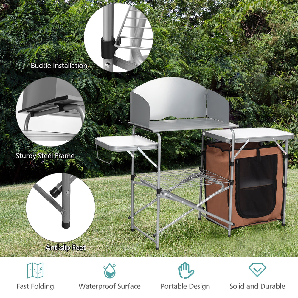 Foldable outdoor BBQ grilling table with windscreen, sturdy aluminum frame, large surface, and zippered storage bag.