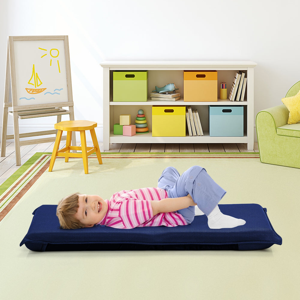 Adjustable navy floor chair with thick padding, shown in a child's playroom for comfortable seating and leisure.