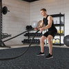 Thick rubber exercise mat set with blue speckles, ideal for workouts in a gym or home fitness space.