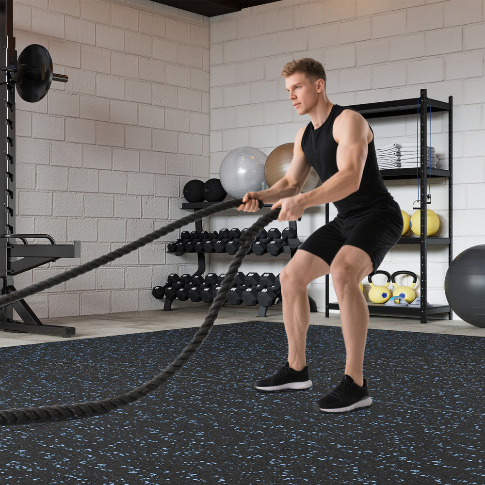 Thick rubber exercise mat set with blue speckles, ideal for workouts in a gym or home fitness space.