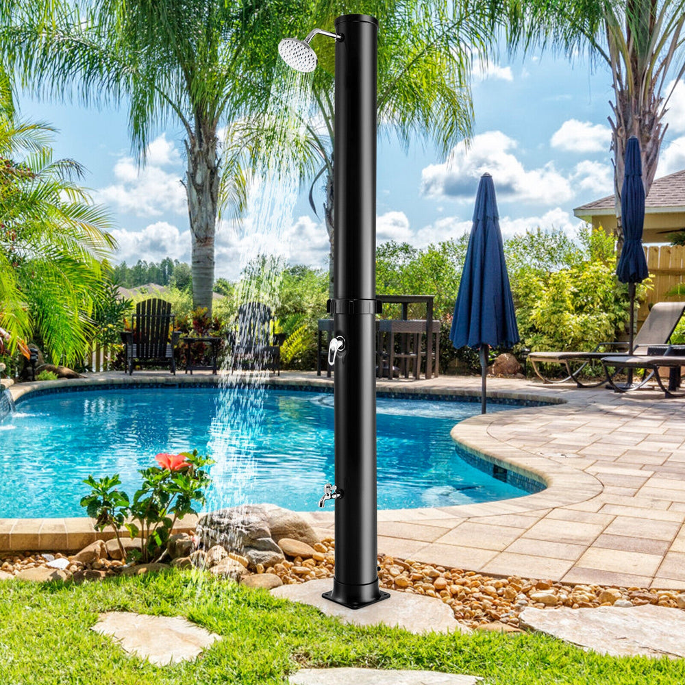Solar-heated outdoor shower in black, featuring a 360° rotating shower head and foot tap, ideal for poolside use.