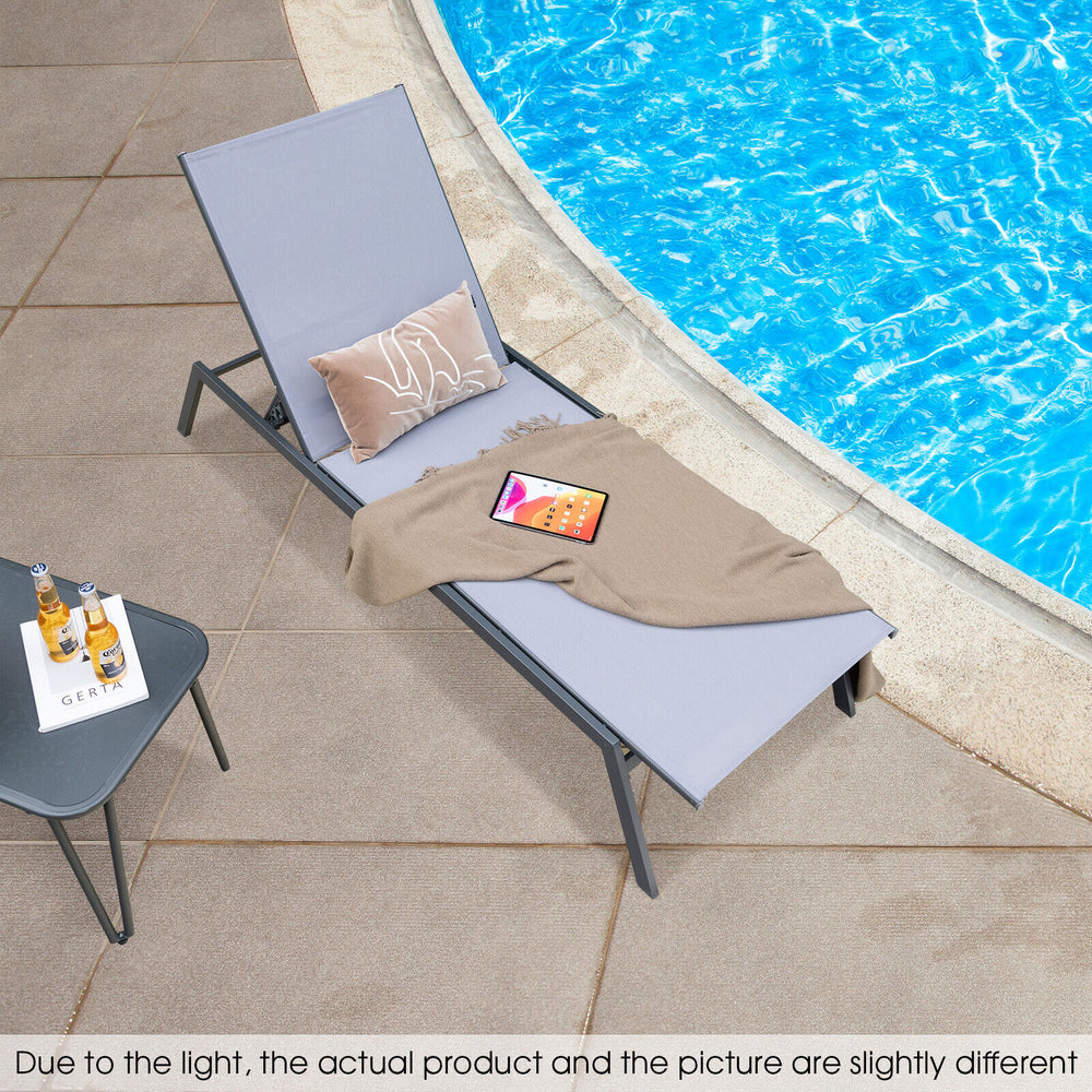 Adjustable outdoor chaise lounge chair in gray with a lay flat position, perfect for poolside relaxation.