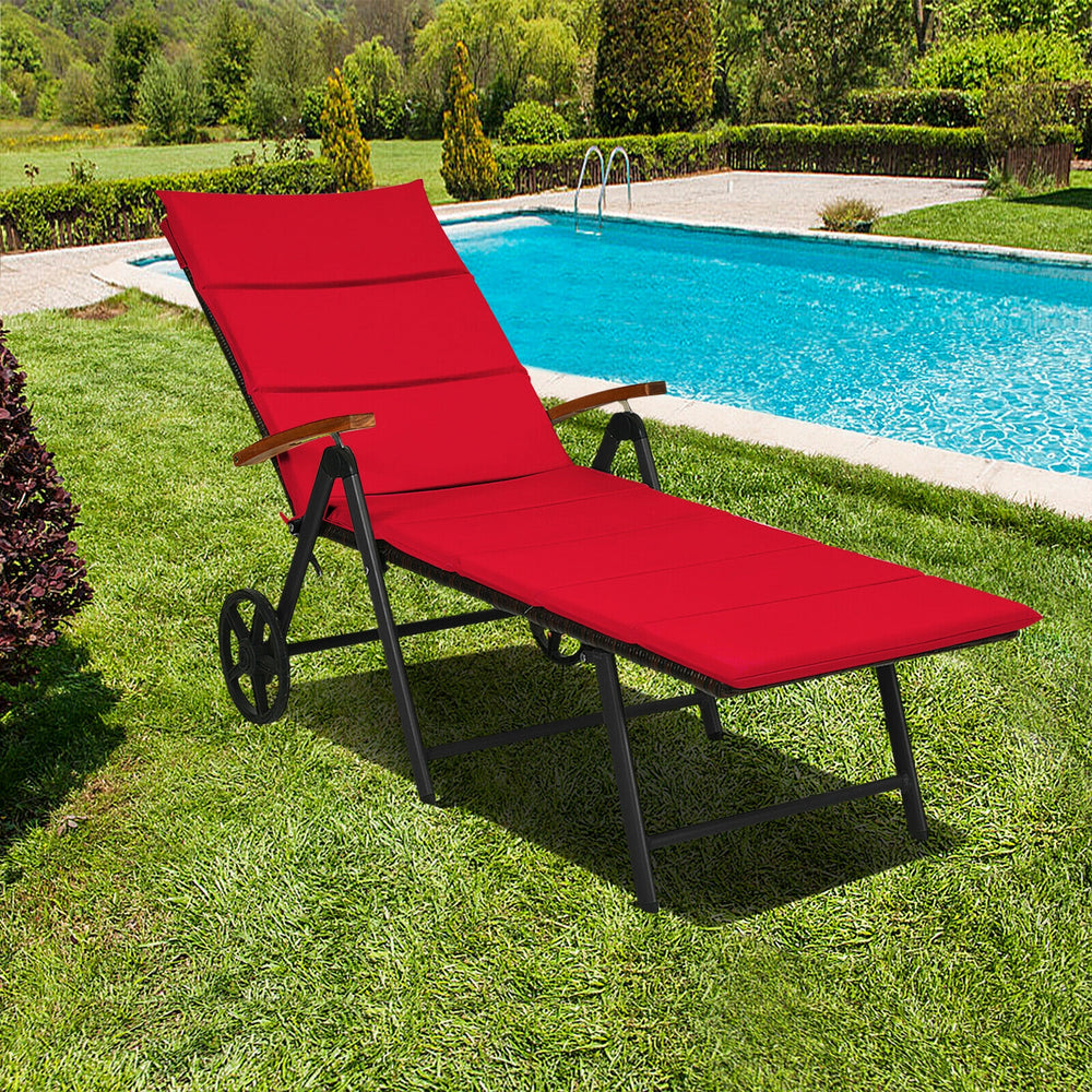 Red folding patio lounge chair with wheels, made of PE rattan and aluminum, ideal for poolside relaxation.
