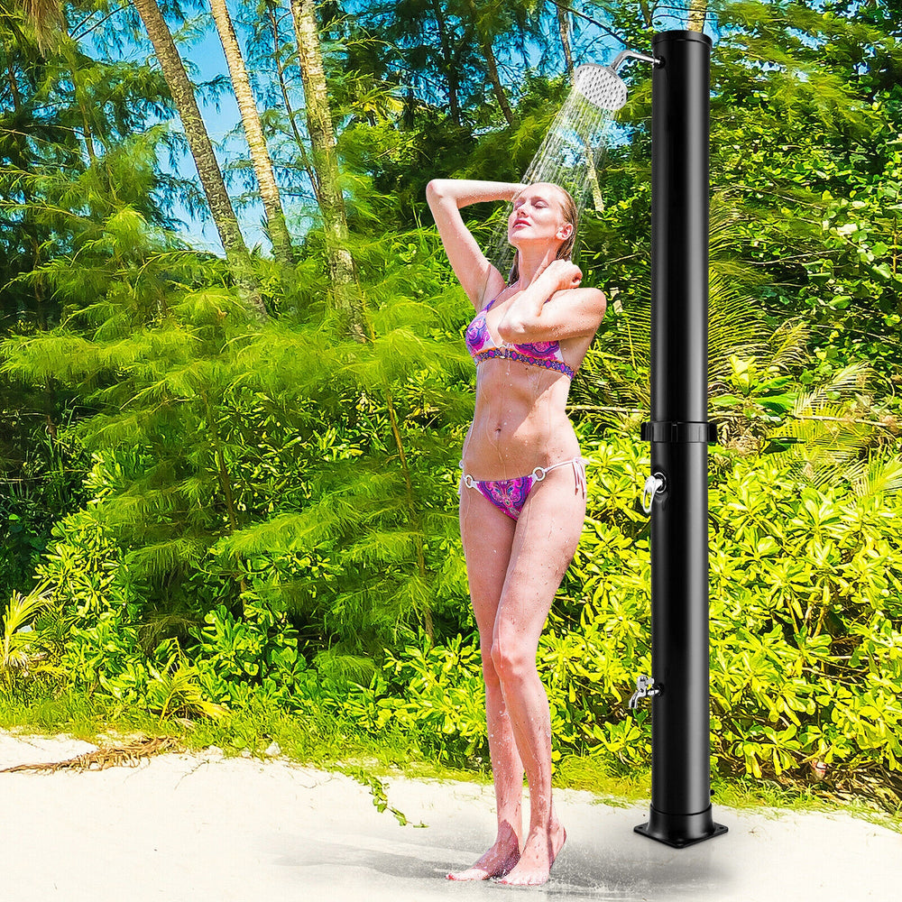 Solar-heated outdoor shower in black, featuring a 360° rotating shower head and foot tap for convenience.