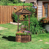 Rustic wooden wishing well with sturdy hexagonal base and long poles for climbing plants, perfect for vibrant garden.