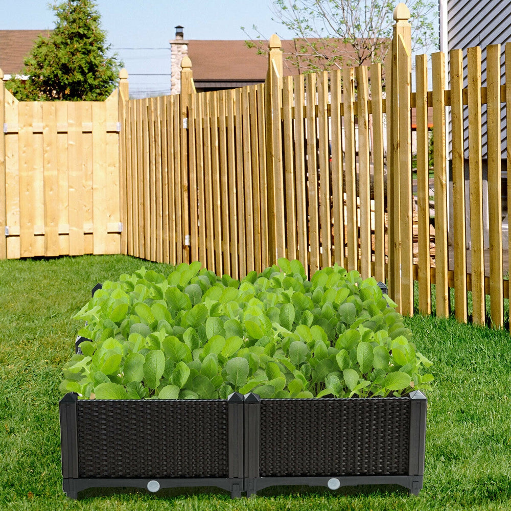 Elevated brown planter box set with lush green plants, perfect for gardening on patios, balconies, or yards.