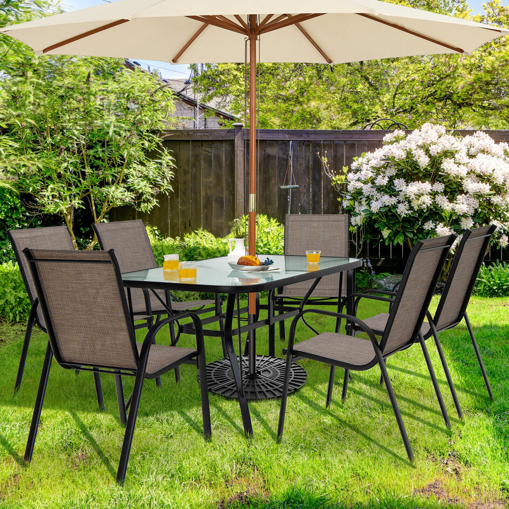 View of six stackable patio dining chairs arranged around a glass table, featuring breathable fabric and a sturdy steel.