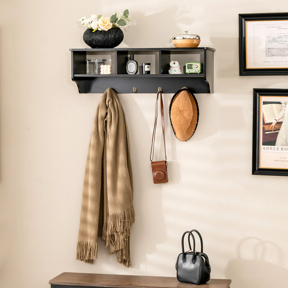 Wall-mounted black cubby organizer with hooks, ideal for entryway storage and displaying decor items.