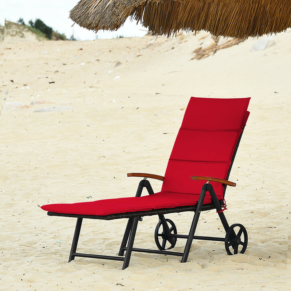 Red folding patio rattan lounge chair with wheels, adjustable backrest, perfect for beach and outdoor relaxation.