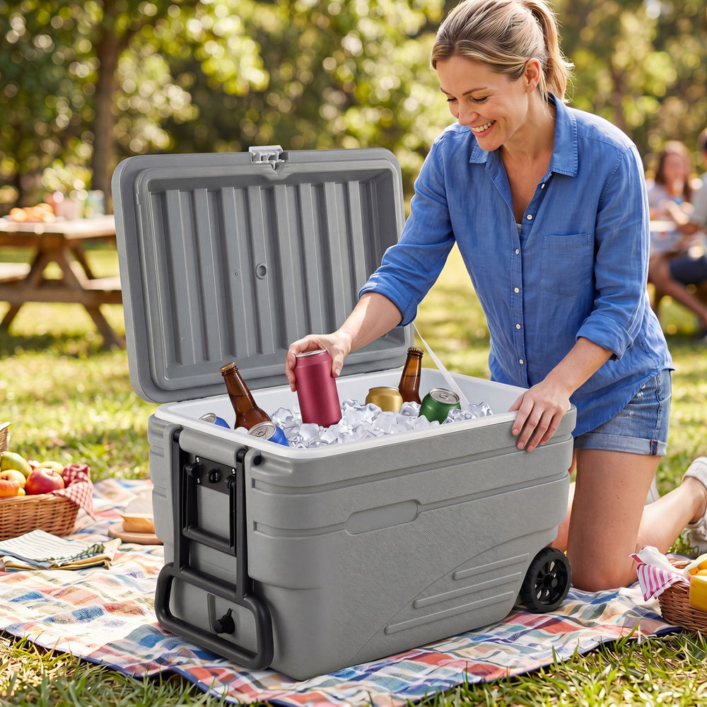 Portable 103 Quart gray wheeled ice cooler with foldable handle, designed for easy transport and ice retention.