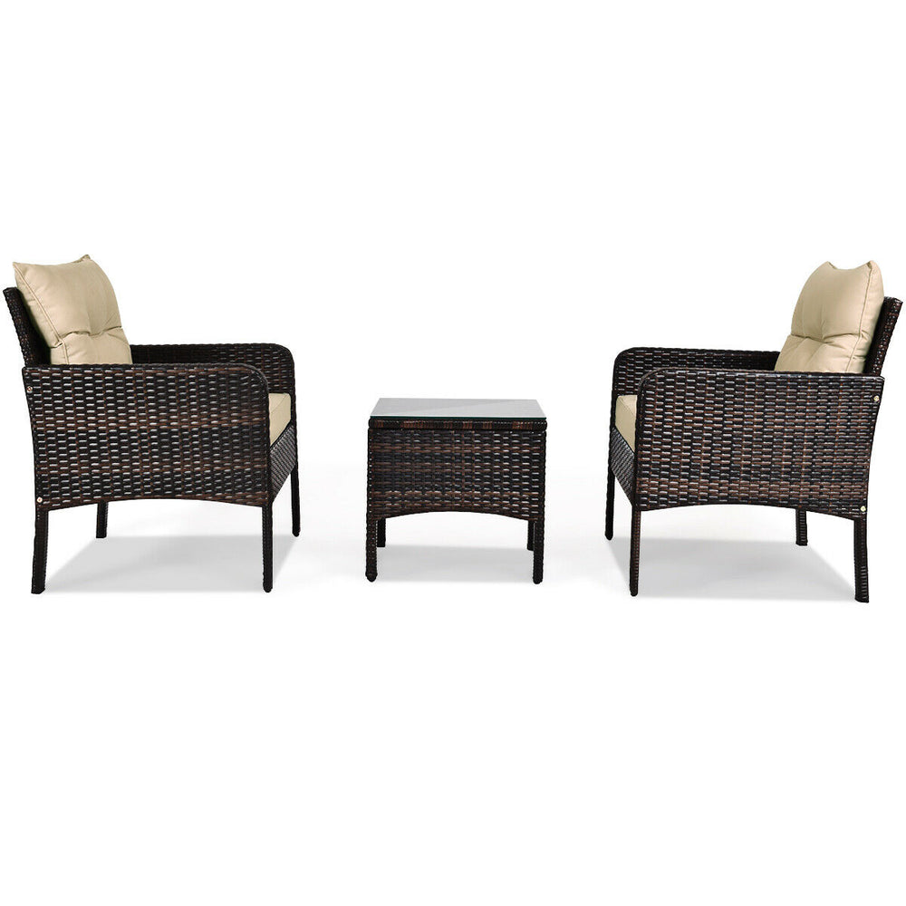 Outdoor patio rattan conversation set with beige cushions, featuring a tempered glass table for backyard relaxation.