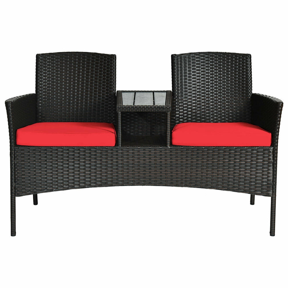 Modern patio conversation set featuring a built-in trapezoid coffee table and red cushions for outdoor comfort.