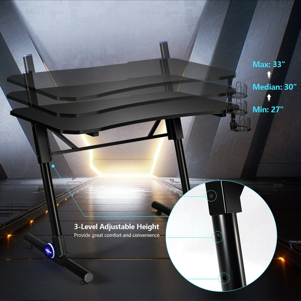 Gaming desk with 3-level height adjustment, carbon fiber texture, and blue LED lights for an ergonomic gaming.