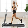 Compact folding treadmill in black with a user jogging, featuring a touch screen and a shock-absorbing running belt.