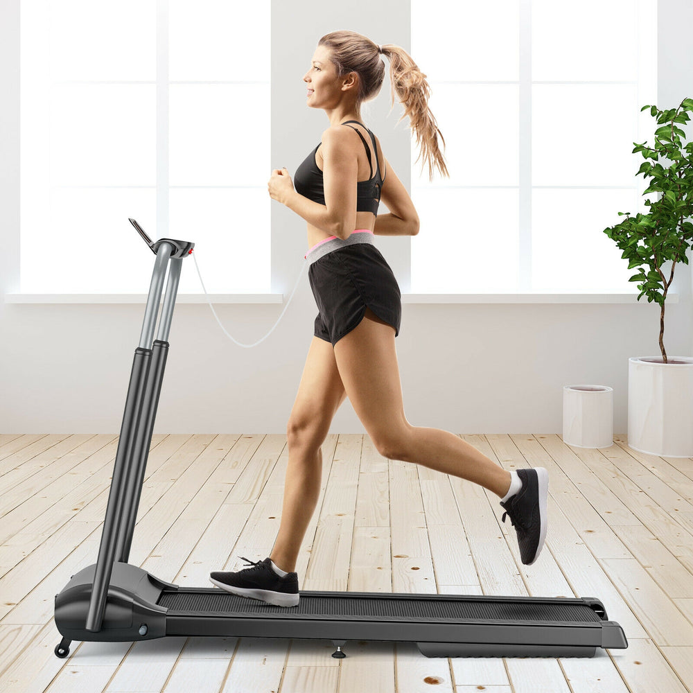 Compact folding treadmill in black with a user jogging, featuring a touch screen and a shock-absorbing running belt.