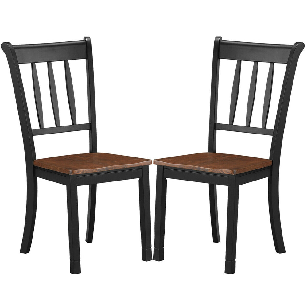 Two solid black spindle back dining chairs with rubber wood seats, perfect for dining rooms and kitchens.