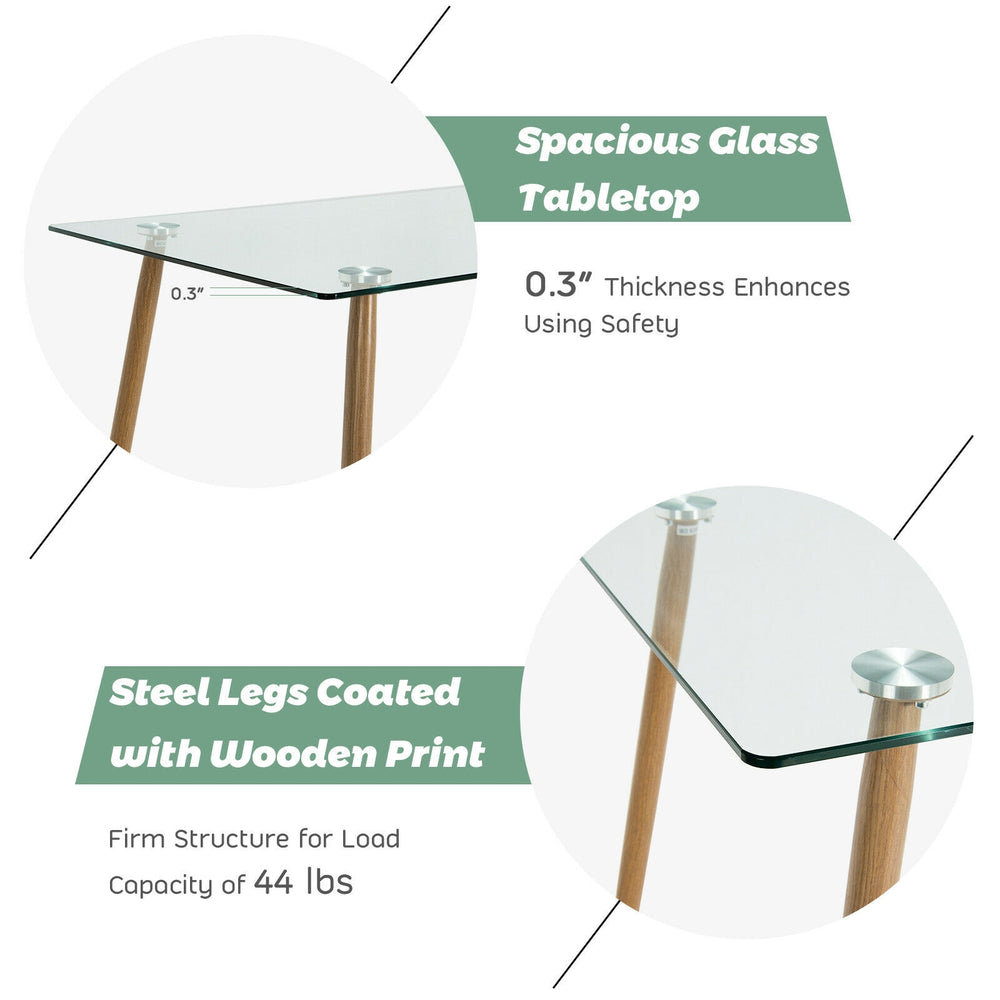 Modern rectangular dining table with a clear glass top and sturdy steel legs, ideal for home or office use.
