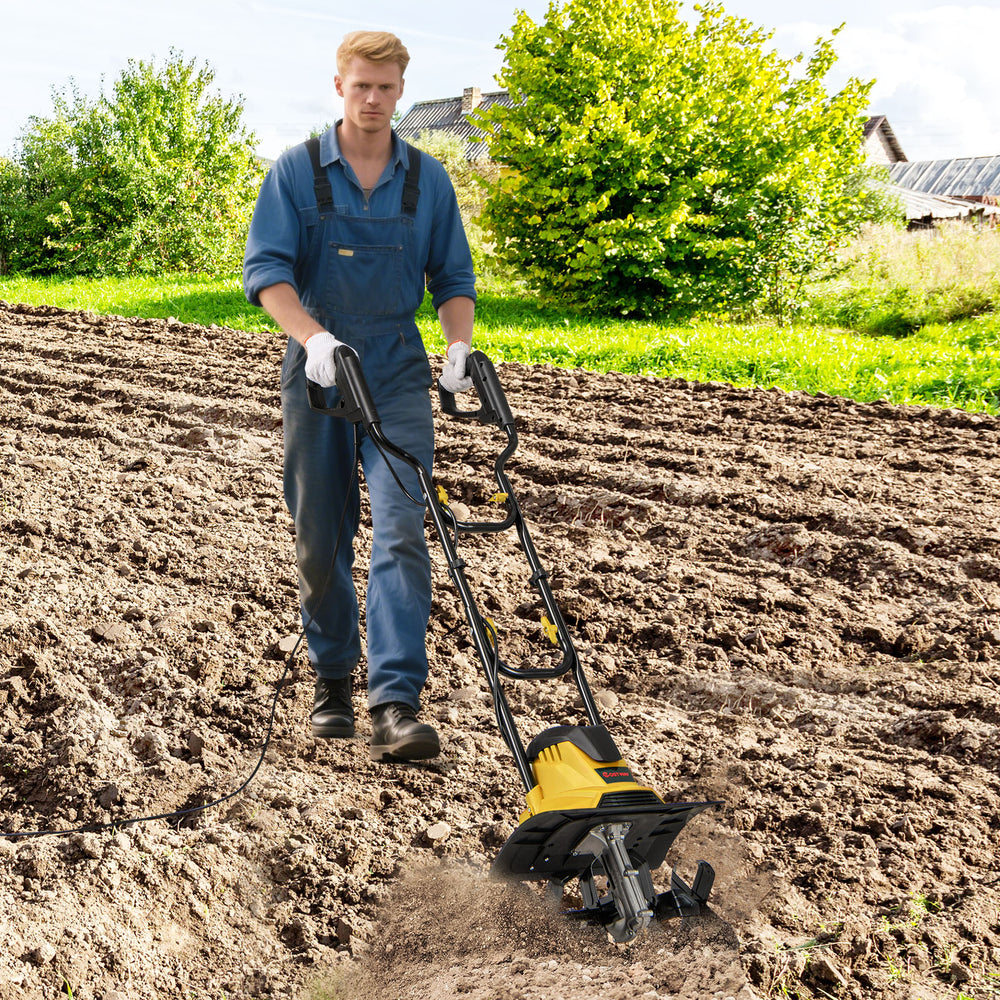Electric tiller cultivator in action, showcasing its 10 Amp motor and 4 angled tines for effective soil cultivation.