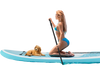 Inflatable stand-up paddle board with a non-slip deck, featuring a golden retriever and a woman paddling in the ocean.