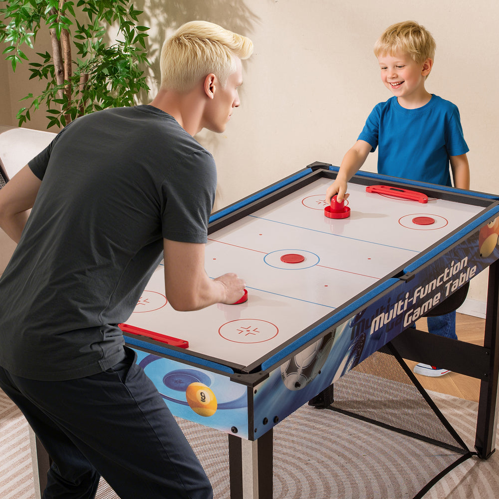 Child and adult playing air hockey on the 10-in-1 combo game table set, featuring a sturdy design and compact size.