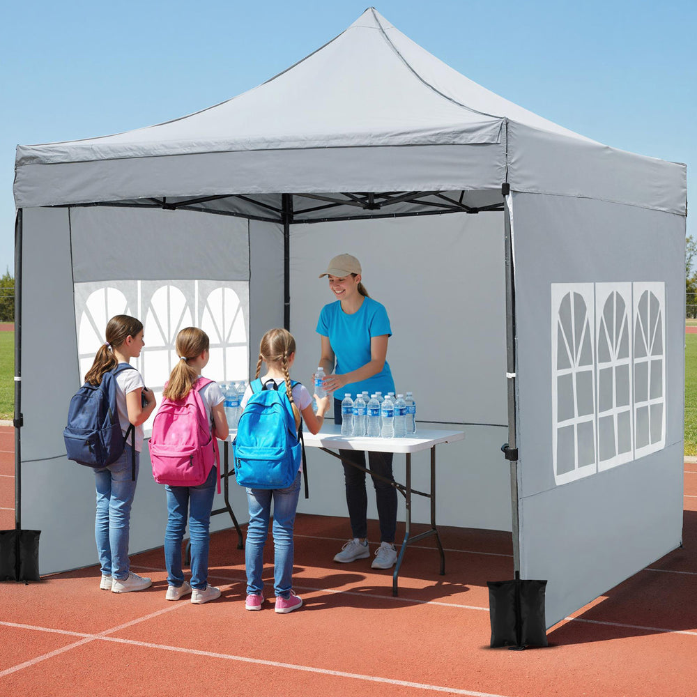 Pop up canopy tent with sidewalls and awning, ideal for outdoor events, featuring a sturdy metal structure and.