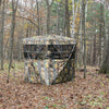 Portable 3-person tent with camouflage design, featuring multiple windows for enhanced visibility in the woods.