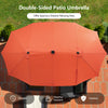 Double-sided patio umbrella in orange provides ample shade for outdoor dining with LED lights for evening ambiance.
