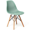 Modern green plastic hollow chair with beech wood legs, ergonomic design for dining or office use.