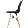 Side view of a black plastic hollow chair with beech wood legs, offering ergonomic support and modern design for dining.