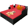 Spacious outdoor rattan daybed in red with upholstered cushions and pillows, perfect for relaxation and comfort.