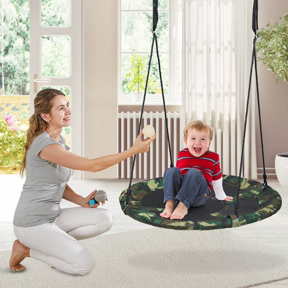 Child enjoying the 40-inch flying saucer tree swing with adjustable ropes, perfect for outdoor play and relaxation.