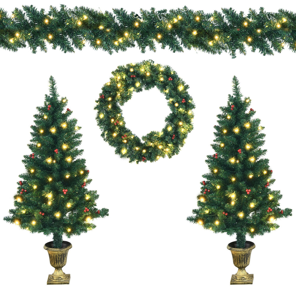 Close-up of a pre-lit Christmas wreath adorned with red berries and LED lights, perfect for festive home decoration.