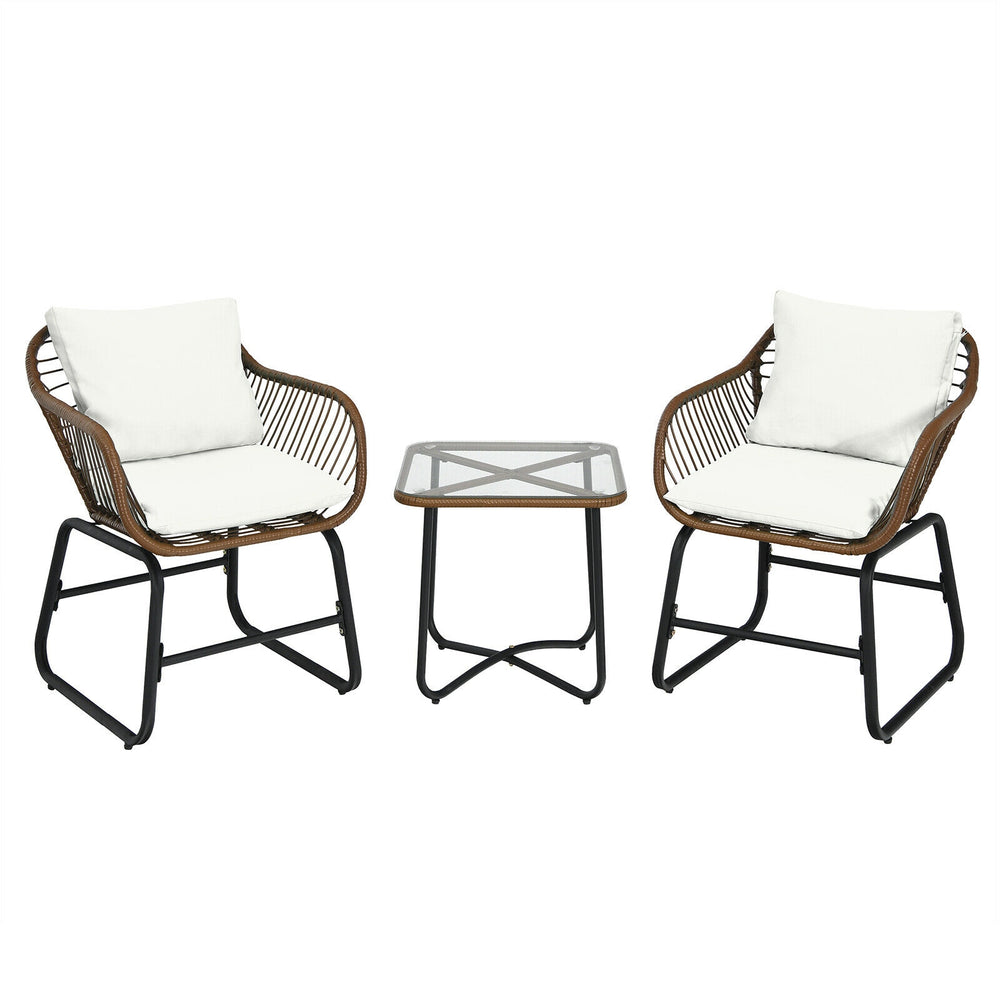Two cushioned armchairs and a glass-top side table from a 3-piece patio rattan bistro set for outdoor relaxation.
