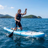 Kneeling paddler on a dark blue 11' inflatable stand-up paddle board, ideal for all skill levels and water adventures.