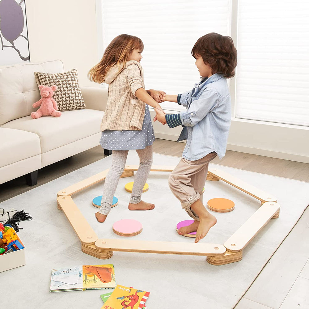 Kids playing on a 12-piece wooden balance beam set with colorful stepping stones, promoting creativity and balance.