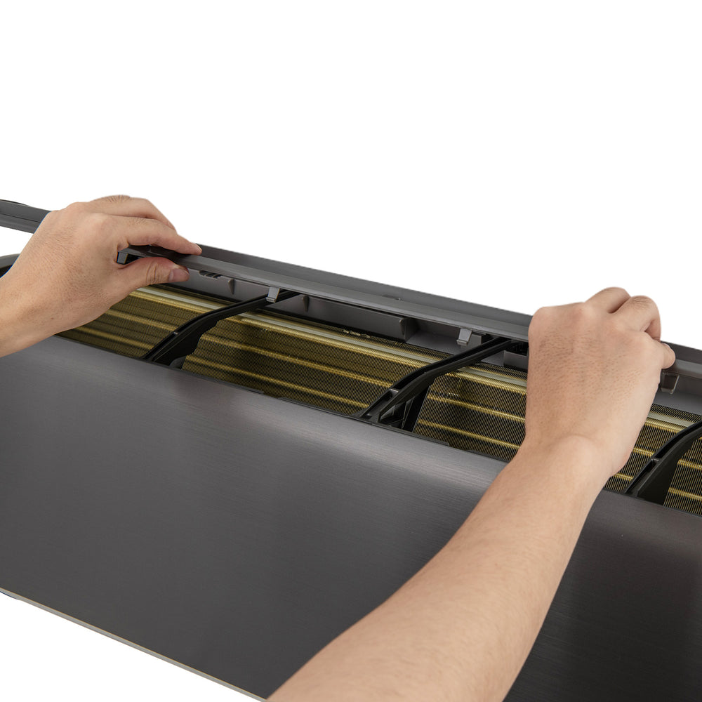 Hands adjusting the top panel of the GreyVolt Mini Split Air Conditioner and Heater for easy maintenance and operation.