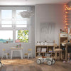 Kid's room featuring a wooden house bed, table and chairs set, and a 2-shelf bookcase for imaginative play and.