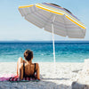 Colorful 6.5 feet beach umbrella with UPF50+ sun protection, tilted for shade, ideal for seaside leisure and camping.