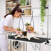 Foldable dog grooming table with height adjustable arms, featuring a non-slip waterproof surface for pet care and.