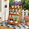 Foldable 3-tier solid wood plant stand with potted plants, ideal for patio or balcony decoration and space-saving.