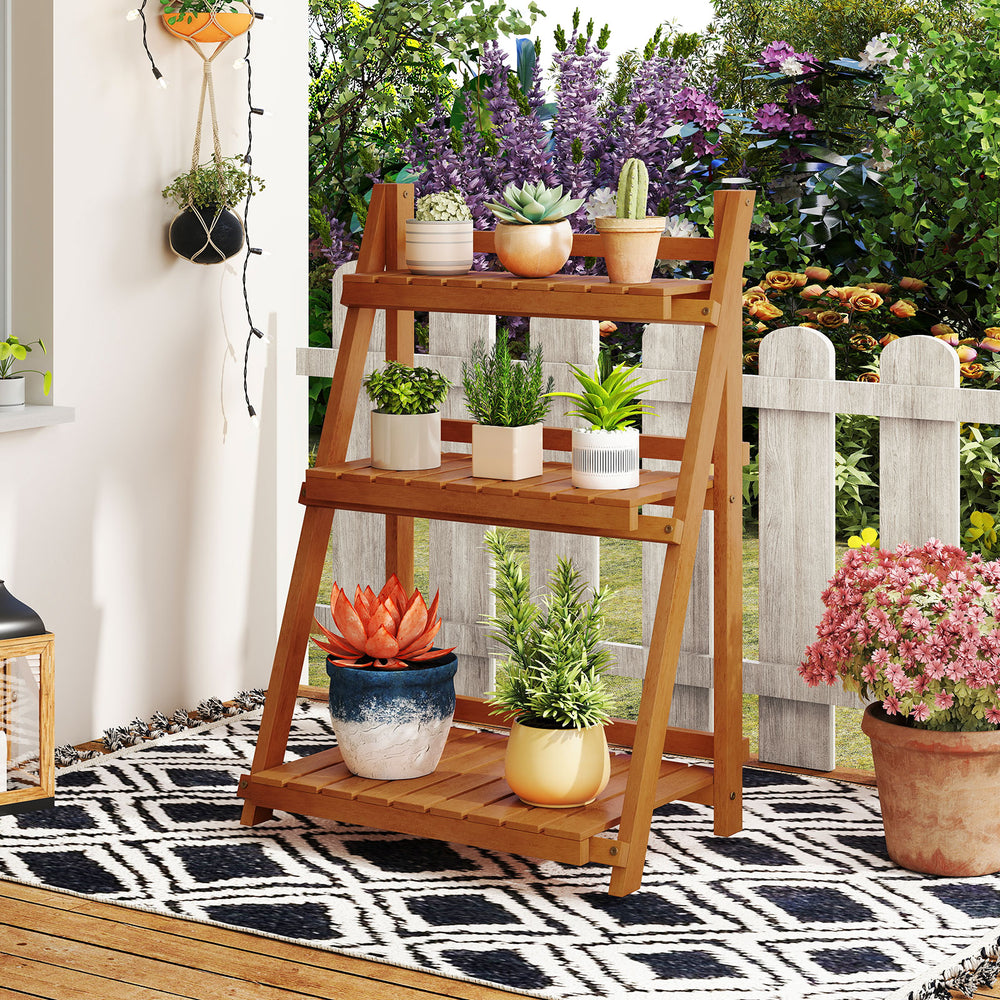Foldable 3-tier solid wood plant stand with potted plants, ideal for patio or balcony decoration and space-saving.