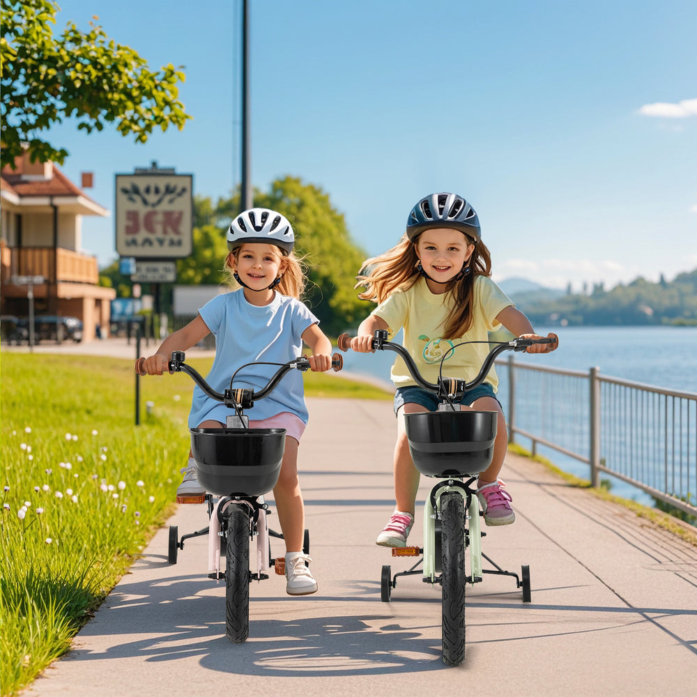 Two girls riding 12-inch kids bikes with training wheels along a scenic pathway by the water, promoting outdoor fun.