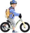 Child riding a 12-inch green balance bike with adjustable seat and rotatable handlebar, perfect for kids over 36 months.