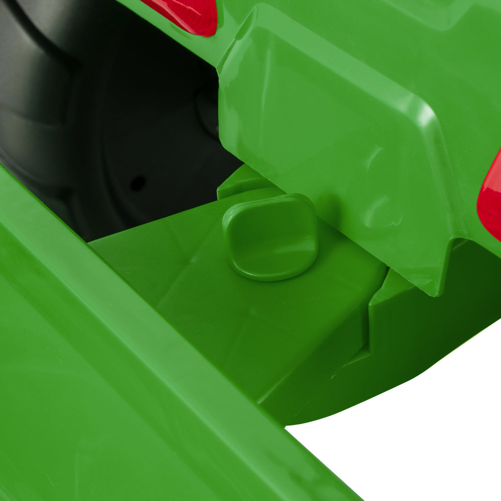 Close-up of the green 12V kids ride-on tractor's trailer attachment, featuring a secure locking mechanism for safe play.