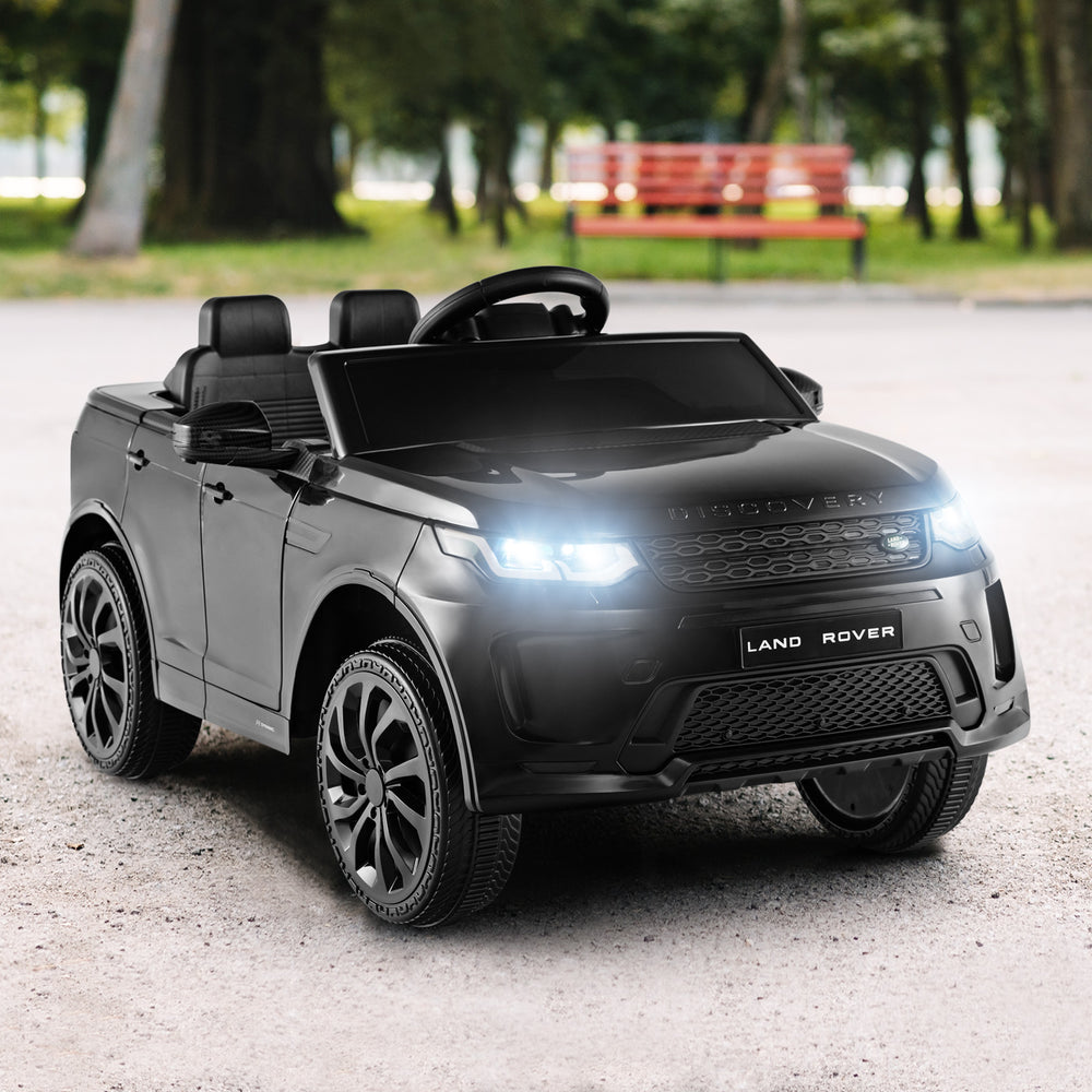 Black 12V kids ride-on car with remote control, LED lights, and realistic design for safe outdoor driving fun.