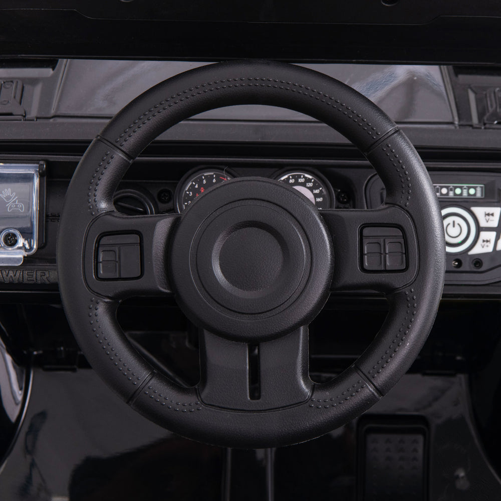 Anti-slip steering wheel of the 12V electric kids ride-on truck with remote control, designed for easy driving.
