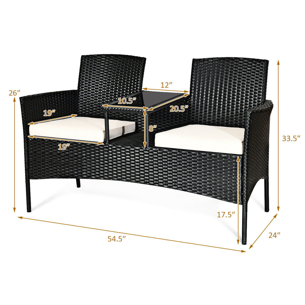 Wicker patio conversation set with removable cushions, featuring a durable steel frame and tempered glass table, ideal.